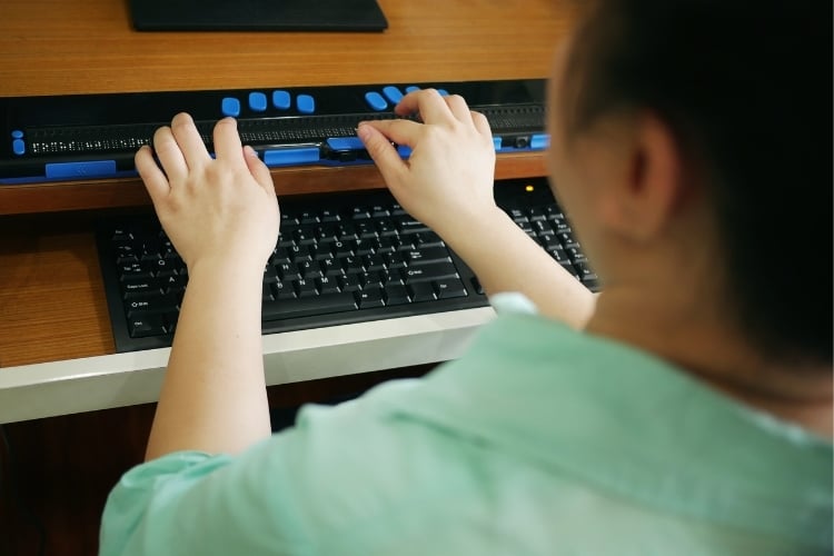 Blind person using braille display
