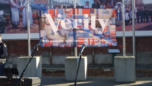 Microphones in front of a Verity CU sign that says "Community"